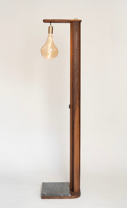 Handmade iN-v1 Walnut and Stone Floor Lamp by Redline Design, with a tall walnut post, hanging amber glass bulb, and a stone base